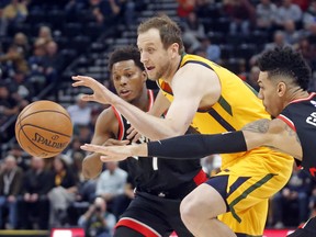 Utah Jazz forward Joe Ingles, center, drives to the basket as Toronto Raptors' Kyle Lowry (7) and Danny Green (14) defend in the first half during an NBA basketball game Monday, Nov. 5, 2018, in Salt Lake City. (AP Photo/Rick Bowmer) ORG XMIT: UTRB118