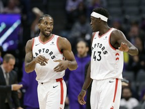 Toronto Raptors forward Kawhi Leonard, left, talks with teammate Toronto Raptors forward Pascal Siakam during the first quarter of an NBA basketball game against the Sacramento Kings, Wednesday, Nov. 7, 2018, in Sacramento, Calif. (AP Photo/Rich Pedroncelli)