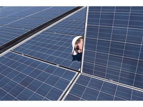 A man inspects solar panels.