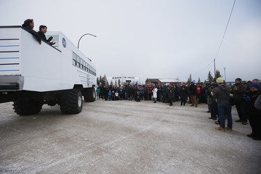Prime Minister Justin Trudeau waves to a crowd from a "Tundra Buggy" after announcing the opening of the repaired railway in Churchill, Manitoba Thursday, November 1, 2018. Prime Minister Justin Trudeau visited Churchill today to announce the opening of the railway and the Port of Churchill. THE CANADIAN PRESS/John Woods