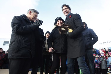 Prime Minister Justin Trudeau receives some slippers from the town of Churchill after announcing the opening of the repaired railway in Churchill, Manitoba Thursday, November 1, 2018. Prime Minister Justin Trudeau visited Churchill today to announce the opening of the railway and the Port of Churchill. THE CANADIAN PRESS/John Woods