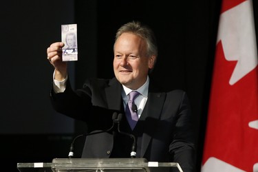 Bank of Canada Governor Stephen Poloz shows off Canada's new $10 banknote at a launch at the Canadian Museum For Human Rights in Winnipeg, Monday, Nov. 19, 2018. The banknote has a portrait of Viola Desmond, the first Canadian woman on a banknote. Poloz and Desmond's sister, Wanda Robson, officially launched the unique, vertically oriented purple bill. THE CANADIAN PRESS/John Woods