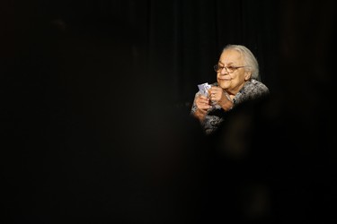Clutching some $10 banknotes Wanda Robson, Viola Desmond's sister, looks at her sister's picture on Canada's new $10 banknote, which has a portrait of Desmond, the first Canadian woman on a banknote, at the Canadian Museum For Human Rights in Winnipeg, Monday, Nov. 19, 2018. Bank of Canada Governor Stephen Poloz and Robson, officially launched the unique, vertically oriented purple bill. THE CANADIAN PRESS/John Woods