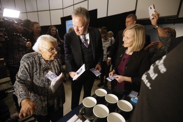 Wanda Robson, Viola Desmond's sister, and Bank of Canada Governor Stephen Poloz spend the first newly designed $10 banknote at a launch of Canada's new $10 banknote, which has a portrait of Desmond, the first Canadian woman on a banknote, at the Canadian Museum For Human Rights in Winnipeg, Monday, Nov. 19, 2018. Bank of Canada Governor Stephen Poloz and Robson, officially launched the unique, vertically oriented purple bill. THE CANADIAN PRESS/John Woods