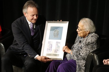 Bank of Canada Governor Stephen Poloz presents a plaque to Wanda Robson, sister of Viola Desmond, at a launch of Canada's new $10 banknote, which has a portrait of Desmond, the first Canadian woman on a banknote, at the Canadian Museum For Human Rights in Winnipeg, Monday, Nov. 19, 2018. Poloz and Desmond's sister, Wanda Robson, officially launched the unique, vertically oriented purple bill. THE CANADIAN PRESS/John Woods