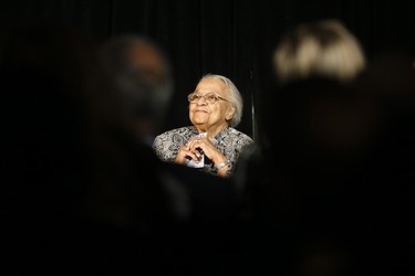 Clutching some $10 banknotes Wanda Robson, Viola Desmond's sister, looks skyward at a launch of Canada's new $10 banknote, which has a portrait of Viola Desmond, the first Canadian woman on a banknote, at the Canadian Museum For Human Rights in Winnipeg, Monday, Nov. 19, 2018. Bank of Canada Governor Stephen Poloz and Robson, officially launched the unique, vertically oriented purple bill. THE CANADIAN PRESS/John Woods