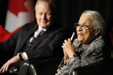 Clutching some $10 banknotes Wanda Robson, Viola Desmond's sister, speaks at a launch of Canada's new $10 banknote, which has a portrait of Desmond, the first Canadian woman on a banknote, at the Canadian Museum For Human Rights in Winnipeg, Monday, Nov. 19, 2018. Bank of Canada Governor Stephen Poloz and Robson, officially launched the unique, vertically oriented purple bill. THE CANADIAN PRESS/John Woods
