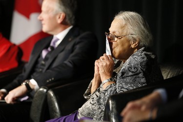 Clutching some $10 banknotes Wanda Robson, Viola Desmond's sister, kisses her sister's picture on Canada's new $10 banknote, which has a portrait of Desmond, the first Canadian woman on a banknote, at the Canadian Museum For Human Rights in Winnipeg, Monday, Nov. 19, 2018. Bank of Canada Governor Stephen Poloz and Robson, officially launched the unique, vertically oriented purple bill. THE CANADIAN PRESS/John Woods