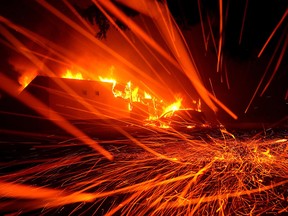 Embers blow in the wind as a Camp Fire burns a KFC on Nov. 8, 2018 in Paradise, Calif.