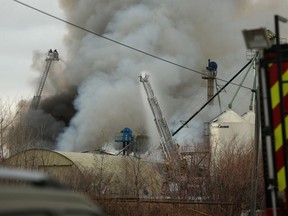 Crews battle a fire at Friendly Family Farms, an oil seed processing plant on Dawson Road in St. Boniface, on Monday.