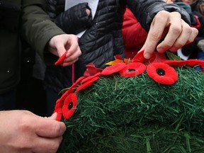 Poppies are pinned to wreaths in front of the cenotaph during the Royal Winnipeg Rifles Association Remembrance Day service at Vimy Ridge Memorial Park in Winnipeg on Sun., Nov. 11, 2018. Kevin King/Winnipeg Sun/Postmedia Network