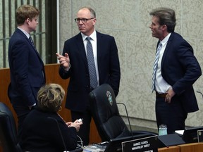 Councillors Scott Gillingham (centre), Kevin Klein (right) and Janice Lukes (seated) speak before an Assiniboia committee meeting at City Hall in Winnipeg, on Tues., Nov. 13, 2018. Kevin King/Winnipeg Sun/Postmedia Network