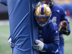 Adam Bighill, his left thumb heavily wrapped, moves a tackling dummy during Winnipeg Blue Bombers practice on Wed., Nov. 14, 2018. Bighill played in the Western Final with a playing cast to protect a fractured thumb. Kevin King/Winnipeg Sun/Postmedia Network