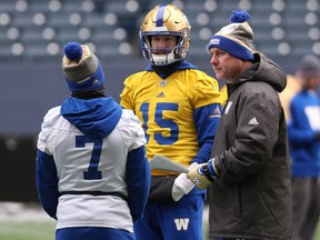 Offensive co-ordinator Paul LaPolice (right) chats with Matt Nichols (centre) and Weston Dressler (left) during Winnipeg Blue Bombers practice last month.
