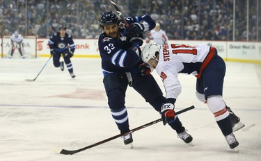 Winnipeg Jets defenceman Dustin Byfuglien (left) gets in the way of Washington Capitals centre Chandler Stephenson in Winnipeg on Wed., Nov. 14, 2018. Kevin King/Winnipeg Sun/Postmedia Network