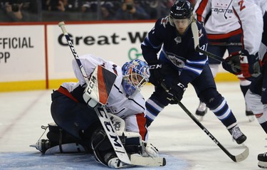 Washington Capitals goaltender Pheonix Copley covers the puck as Winnipeg Jets forward Kyle Connor awaits a rebound in Winnipeg on Wed., Nov. 14, 2018. Kevin King/Winnipeg Sun/Postmedia Network