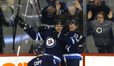 Winnipeg Jets defenceman Ben Chiarot (centre) celebrates his game-winning goal against the Washington Capitals in Winnipeg with Andrew Copp (left) and Brandon Tanev on Wed., Nov. 14, 2018. Kevin King/Winnipeg Sun/Postmedia Network