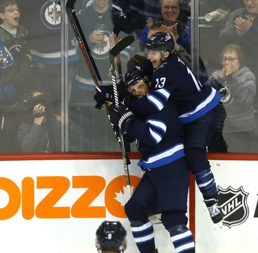 Winnipeg Jets defenceman Ben Chiarot is mounted by forward Brandon Tanev after his game-winning goal against the Washington Capitals in Winnipeg on Wed., Nov. 14, 2018. Kevin King/Winnipeg Sun/Postmedia Network