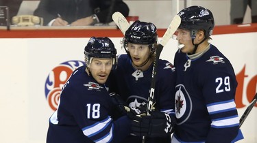 Winnipeg Jets forward Kyle Connor is congratulated on his empty-net goal against the Washington Capitals in Winnipeg by Bryan Little (left) and Patrik Laine on Wed., Nov. 14, 2018. Kevin King/Winnipeg Sun/Postmedia Network