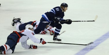 Winnipeg Jets forward Kyle Connor hits the empty net despite the efforts of Washington Capitals forwards Lars Eller (left) and Tom Wilson in Winnipeg on Wed., Nov. 14, 2018. Kevin King/Winnipeg Sun/Postmedia Network