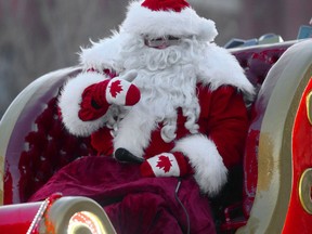 Santa Claus waves to his thousands of fans during the Winnipeg Santa Claus Parade in downtown Winnipeg, on Saturday.