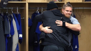Adam Bighill (right) hugs Chris Randle in the Winnipeg Blue Bombers locker room on Mon., Nov. 19, 2018. Kevin King/Winnipeg Sun/Postmedia Network