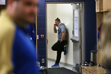 Adam Bighill talks on the phone in the Winnipeg Blue Bombers locker room on Mon., Nov. 19, 2018. Kevin King/Winnipeg Sun/Postmedia Network