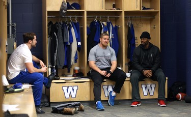 Adam Bighill (centre) speaks with Thomas Miles (left) and Chris Randle in the Winnipeg Blue Bombers locker room on Mon., Nov. 19, 2018. Kevin King/Winnipeg Sun/Postmedia Network