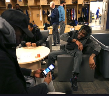 Corey Washington (right) laughs about something on his phone he shared with Kenbrell Thompkins (left) in the Winnipeg Blue Bombers locker room on Mon., Nov. 19, 2018. Kevin King/Winnipeg Sun/Postmedia Network