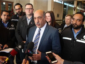 Aleem Chaudhary, president of the Amalgamated Transit Union Local 1505, speaks to reporters at City Hall in Winnipeg on Tuesday, Nov. 27, 2018, as Winnipeg Transit drivers look on. JOYANNE PURSAGA/Winnipeg Sun/Postmedia Network