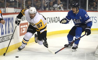 Pittsburgh Penguins centre Sidney Crosby (left) is pursued by Winnipeg Jets centre Mark Scheifele in Winnipeg on Tues., Nov. 27, 2018. Kevin King/Winnipeg Sun/Postmedia Network
