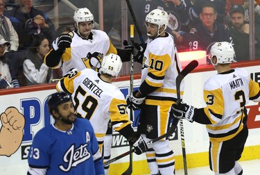 Pittsburgh Penguins forward Zach Aston-Reese (top left) celebrates his game-winning goal to beat the Winnipeg Jets in Winnipeg with Jake Guentzel, Garrett Wilson and Olli Maata (from left) on Tues., Nov. 27, 2018. Kevin King/Winnipeg Sun/Postmedia Network