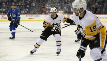 Pittsburgh Penguins centre Sidney Crosby (centre) winds up for a drop pass that never arrived against the Winnipeg Jets in Winnipeg on Tues., Nov. 27, 2018. Kevin King/Winnipeg Sun/Postmedia Network
