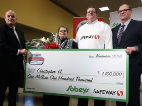 Chris Haley (centre) and his wife Karen pose with representatives of Sobeys Safeway during a press event at the River East Safeway on Henderson Highway in Winnipeg on Wed., Nov. 28, 2018. Haley won $1.1 million plus $1,000 in gift cards in the Sobeys Safeway $1,000,000 Score and Win thanks to Winnipeg Jets sniper Patrik Laine potting five goals against the St. Louis Blues on Saturday night. Kevin King/Winnipeg Sun/Postmedia Network