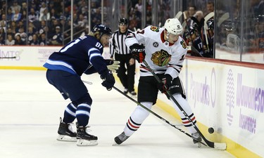 Winnipeg Jets forward Kyle Connor (right) picks the pocket of Chicago Blackhawks centre Dylan Strome in Winnipeg on Thurs., Nov. 29, 2018. Kevin King/Winnipeg Sun/Postmedia Network