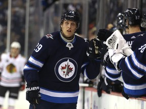 Winnipeg Jets forward Patrik Laine celebrates his 100th career goal, against the Chicago Blackhawks in Winnipeg on Thursday.