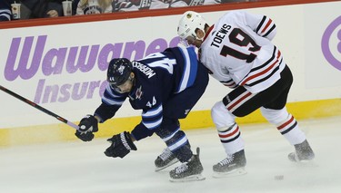 Winnipeg Jets defenceman Josh Morrissey (left) gets turned around by Chicago Blackhawks centre Jonathan Toews in Winnipeg on Thurs., Nov. 29, 2018. Kevin King/Winnipeg Sun/Postmedia Network