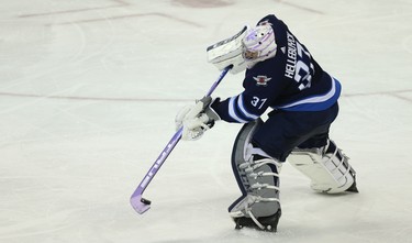 Winnipeg Jets goaltender Connor Hellebuyck comes out of his net to clear the puck against the Chicago Blackhawks in Winnipeg on Thurs., Nov. 29, 2018. Kevin King/Winnipeg Sun/Postmedia Network