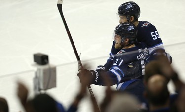 Winnipeg Jets forward Nikolaj Ehlers (left) and centre Mark Scheifele celebrate the third goal of the night from Ehlers against the Chicago Blackhawks in Winnipeg on Thurs., Nov. 29, 2018. Kevin King/Winnipeg Sun/Postmedia Network