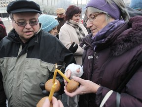 Peter Manastyrsky (left) and Margaret Friesen light candles at a memorial service for the Holodomor at Winnipeg City Hall Saturday, Nov. 26, 2011. The Holodomor was a forced starvation of Ukrainians by Russsians in the 1930's where over four million people died.
