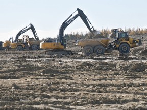 Workers scramble to build an emergency channel to lower water levels of lakes Manitoba and St. Martin in the fall of 2008.