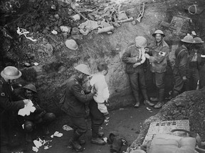 Wounded soldiers are treated in a trench during the Battle of Courcelette. Sept. 15, 1916. THE CANADIAN PRESS/HO, Library and Archives Canada