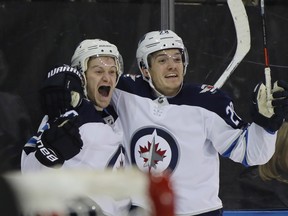 Winnipeg Jets' Bryan Little (left) celebrates his game-tying goal against the Rangers in New York on Sunday. (GETTY IMAGES)