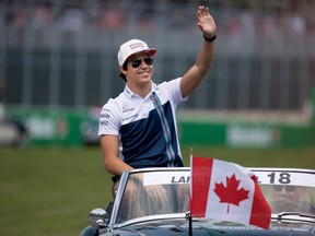 Lance Stroll waves to the fans during the driver's parade at the Canadian Formula 1 Grand Prix at Circuit Gilles Villeneuve in Montreal on June 11, 2017.