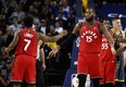 OAKLAND, CA - DECEMBER 12: Greg Monroe #15 of the Toronto Raptors is congratulated by Kyle Lowry #7 after he was fouled by the Golden State Warriors at ORACLE Arena on December 12, 2018 in Oakland, California. NOTE TO USER: User expressly acknowledges and agrees that, by downloading and or using this photograph, User is consenting to the terms and conditions of the Getty Images License Agreement. (Photo by Ezra Shaw/Getty Images)