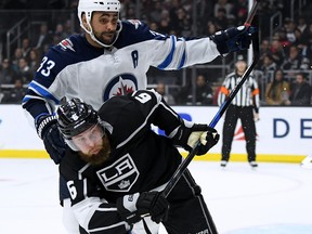 Jake Muzzin #6 of the Los Angeles Kings and Dustin Byfuglien #33 of the Winnipeg Jets bump as they chase after the puck during the second period at Staples Center on Tuesday night.   (Photo by Harry How/Getty Images)