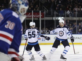 NEW YORK, NEW YORK - DECEMBER 02: Mark Scheifele #55 and Blake Wheeler #26 of the Winnipeg Jets celebrate a 4-3 shootout win on a goal by Scheifele against Henrik Lundqvist #30 of the New York Rangers at Madison Square Garden on December 02, 2018 in New York City. (Photo by Bruce Bennett/Getty Images)