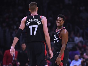 Toronto Raptors' Kyle Lowry and Jonas Valanciunas share a laugh during Tuesday's win over the L.A. Clippers. (GETTY IMAGES)