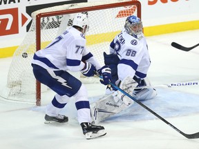 Winnipeg Jets centre Mark Scheifele (right) buries a rebound past Tampa Bay Lightning goaltender Andrei Vasilevskiy in overtime on Sunday night in Winnipeg. (Kevin King/Winnipeg Sun)