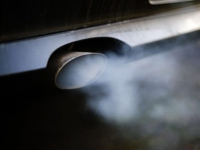 Exhaust pours from the tailpipe of car.